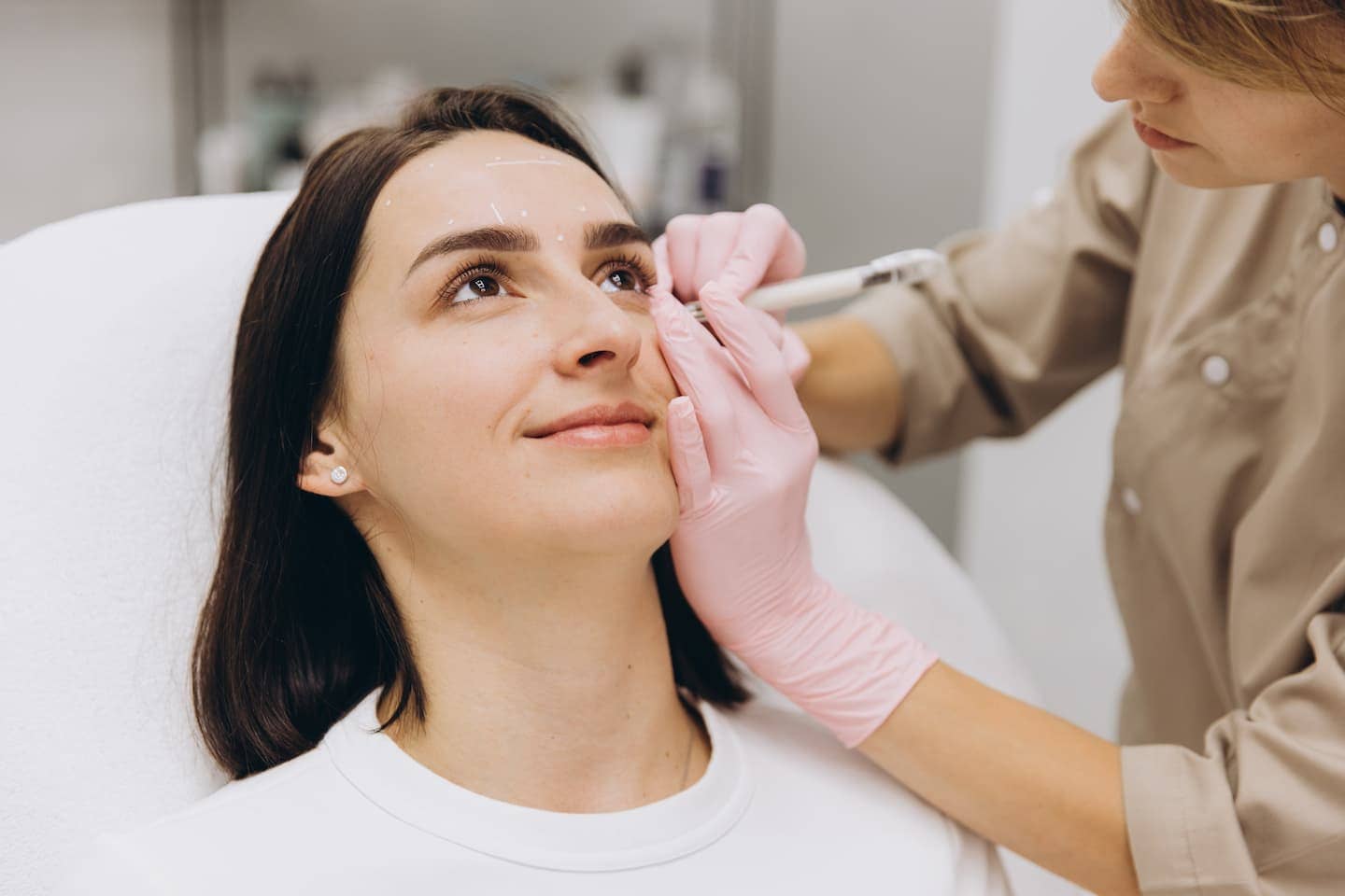 Woman gently touching her lips after lip filler aftercare recovery